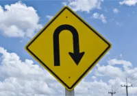 A yellow sign with an arrow pointing to the left.