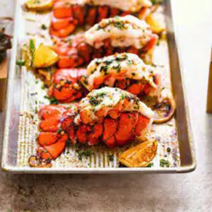A tray of lobster with lemon and herbs.
