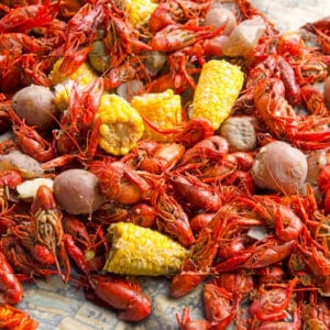 A pile of crawfish and corn on the cob.