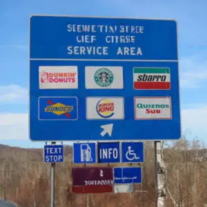 A blue sign with several different signs on it.